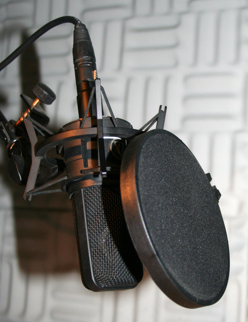 Studio microphone with pop filter illustrating charlie kirk podcast archive documentation